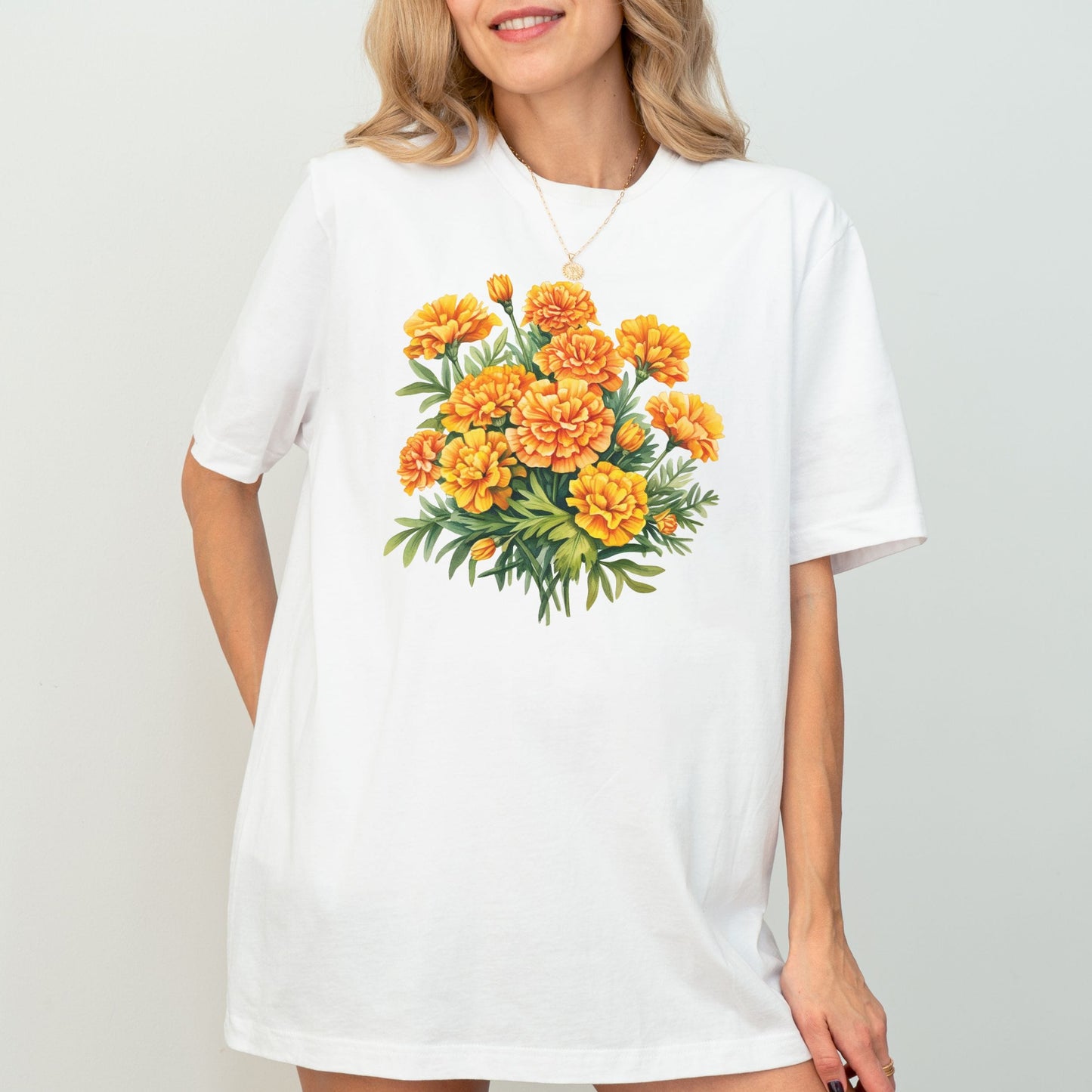 Woman wearing a white t-shirt with a floral design on a plain background