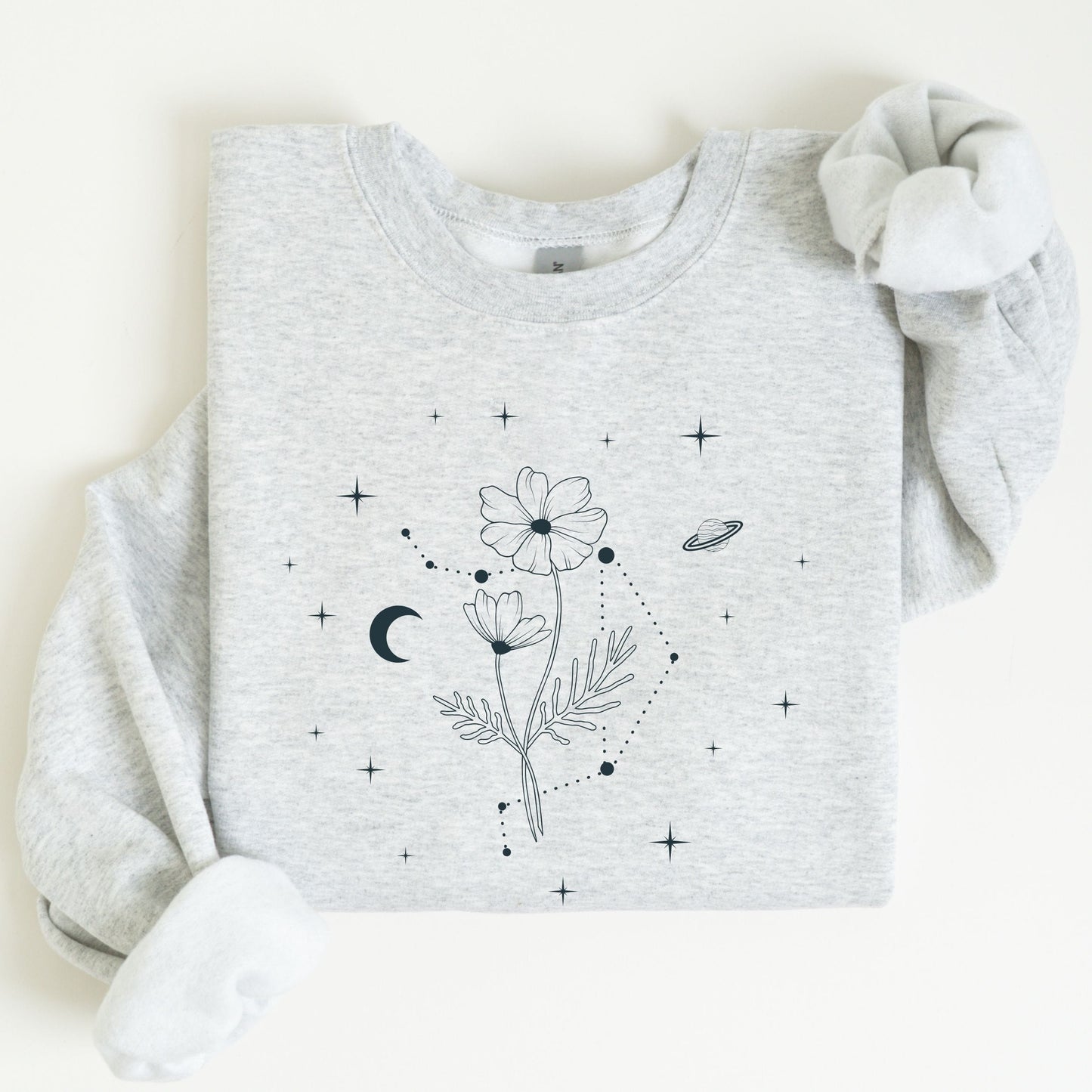 Gray sweatshirt with floral and celestial design on a white background