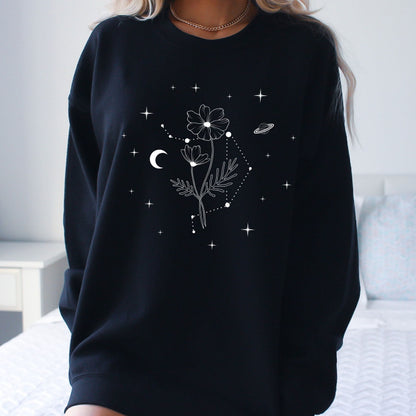 Black sweatshirt with floral and celestial design worn by a person.