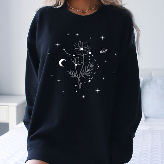 Black sweatshirt with floral and celestial design worn by a person.