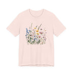 Flat lay of soft pink t-shirt with pastel watercolor wildflowers