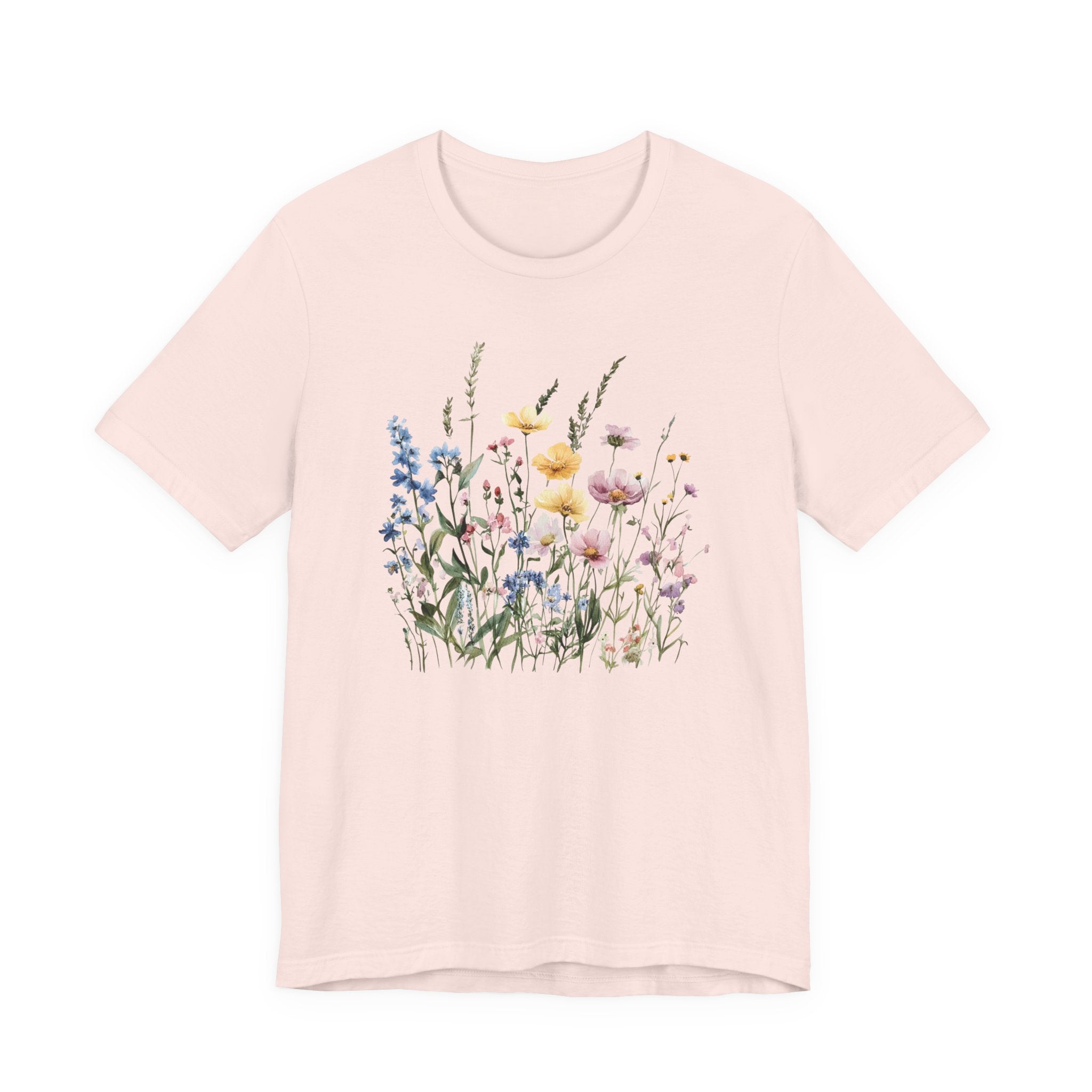 Flat lay of soft pink t-shirt with pastel watercolor wildflowers