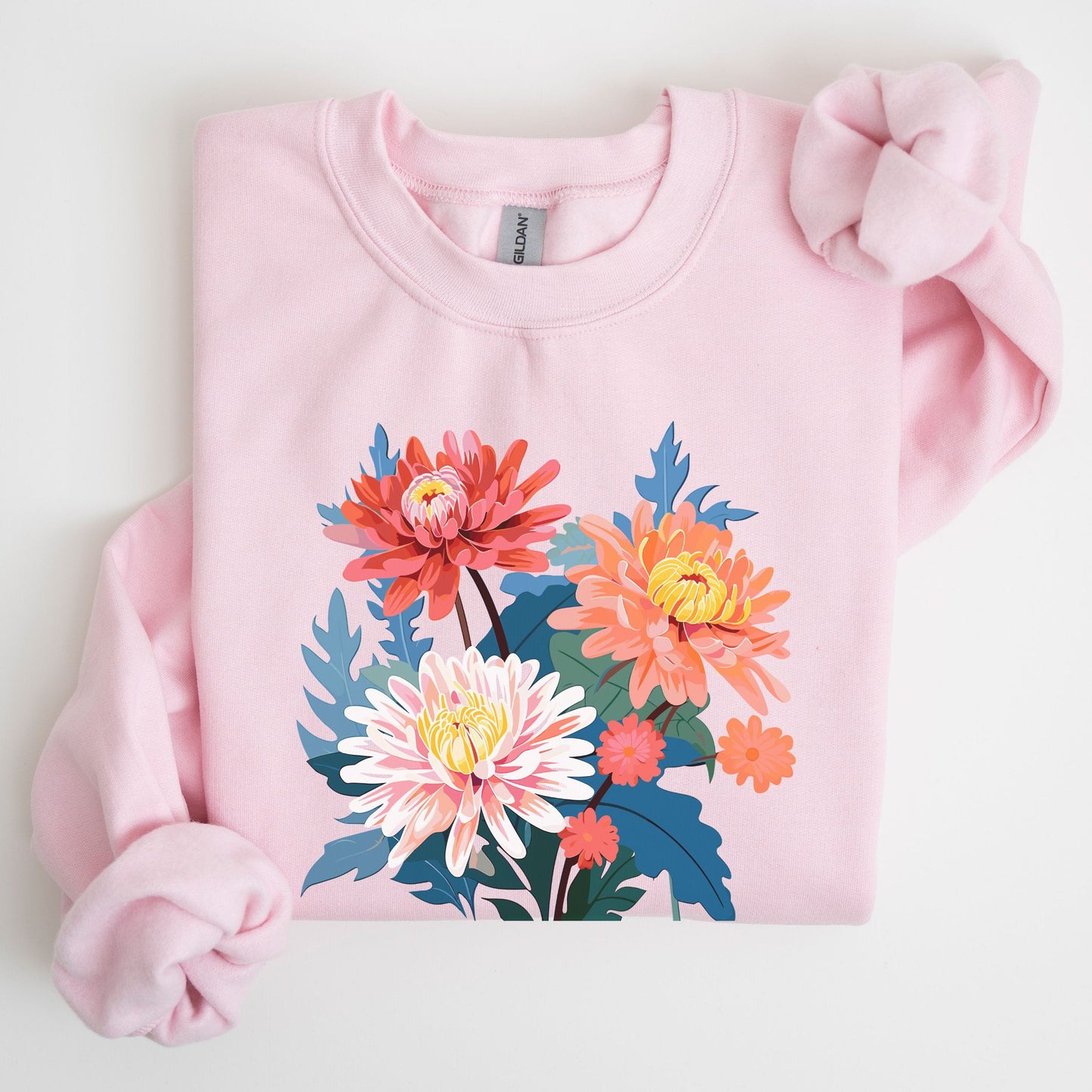 Pink sweatshirt with floral design on a light gray background