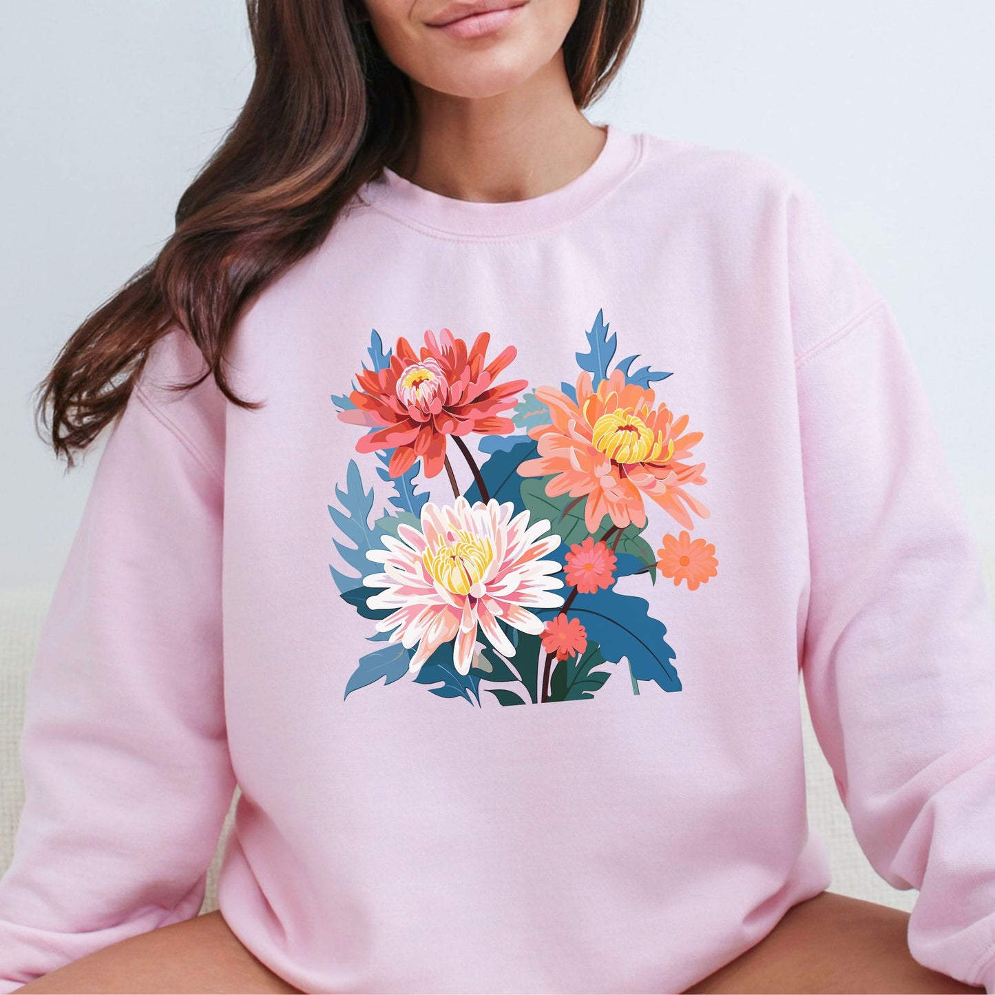 Pink sweatshirt with floral design worn by a person