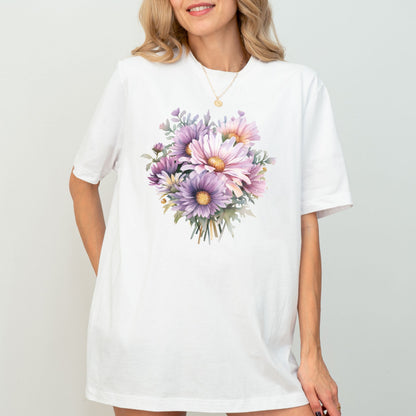Woman wearing a white t-shirt with a floral design on a plain background
