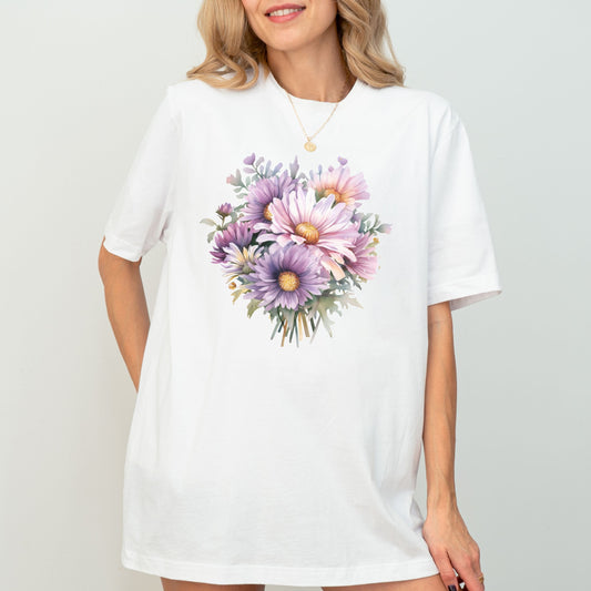 Woman wearing a white t-shirt with a floral design on a plain background