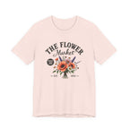 Pink t-shirt with 'The Flower Market' graphic design on a white background
