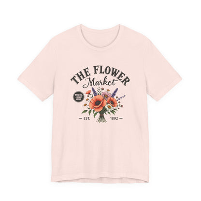 Pink t-shirt with 'The Flower Market' graphic design on a white background