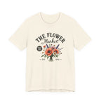 Beige t-shirt with 'The Flower Market' graphic design on a white background