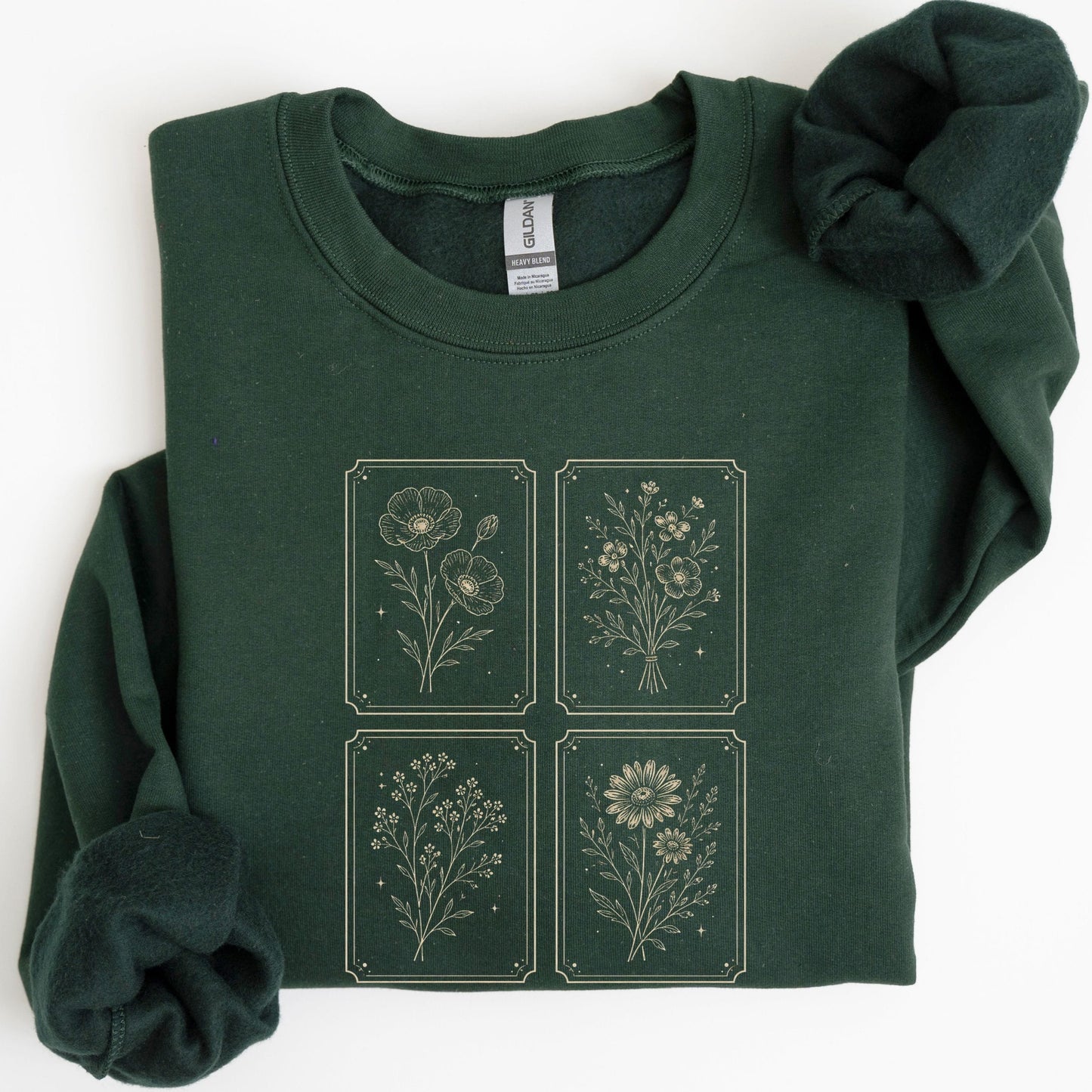 Green sweatshirt with floral designs on a white background