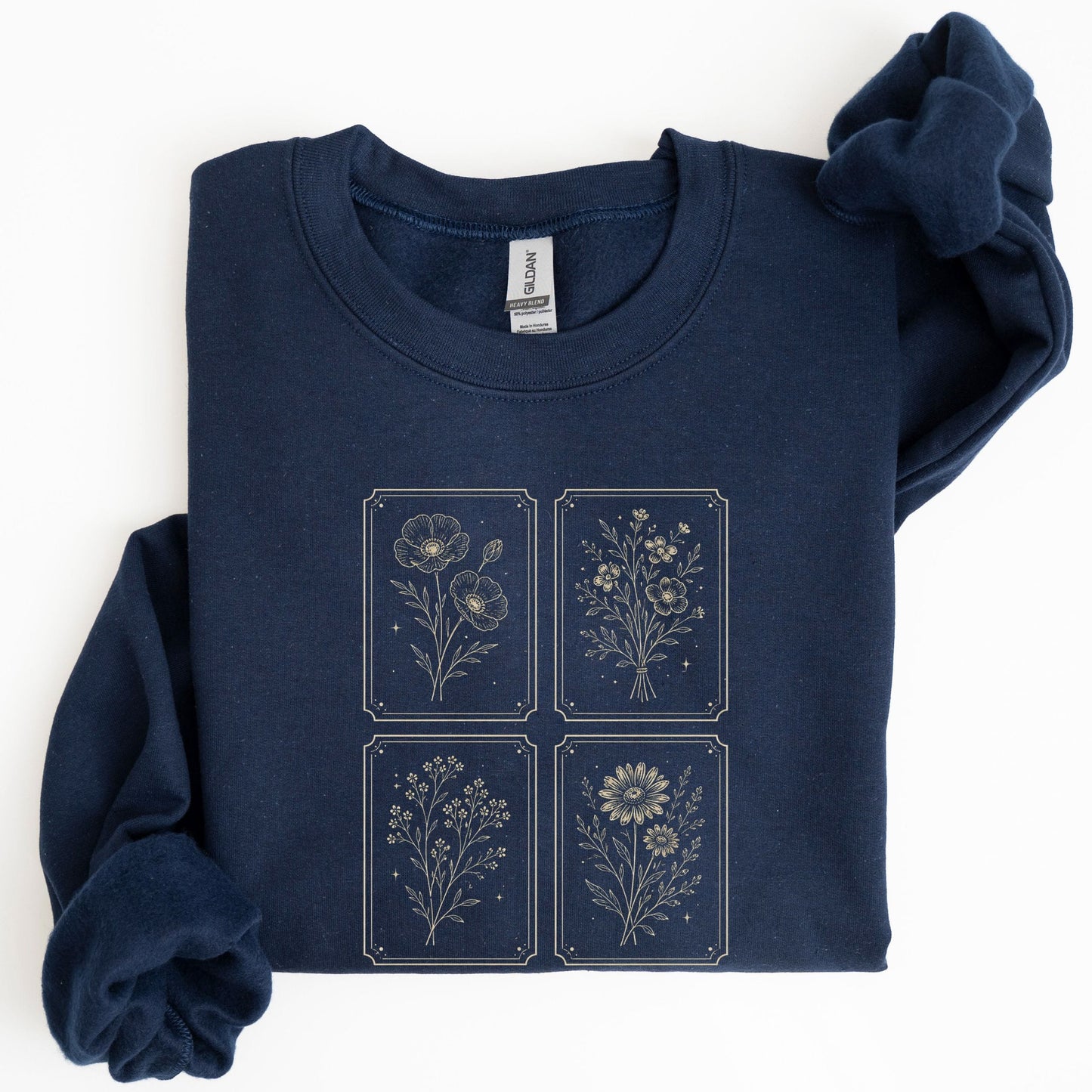 Folded navy blue sweatshirt with floral designs on a white background