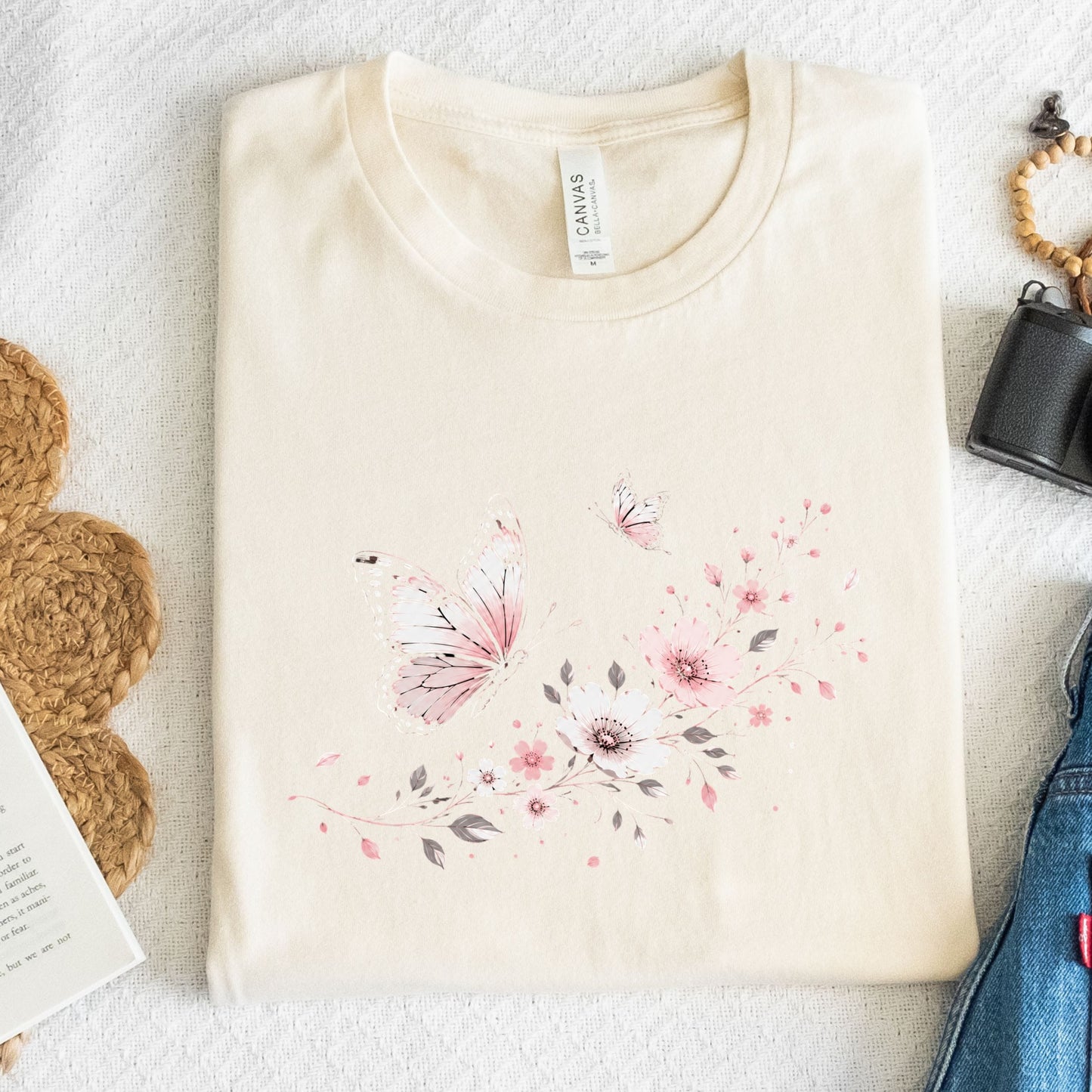 Beige t-shirt with floral design on a textured surface
