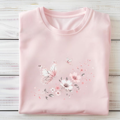 Folded pink t-shirt with floral and butterfly design on a wooden surface