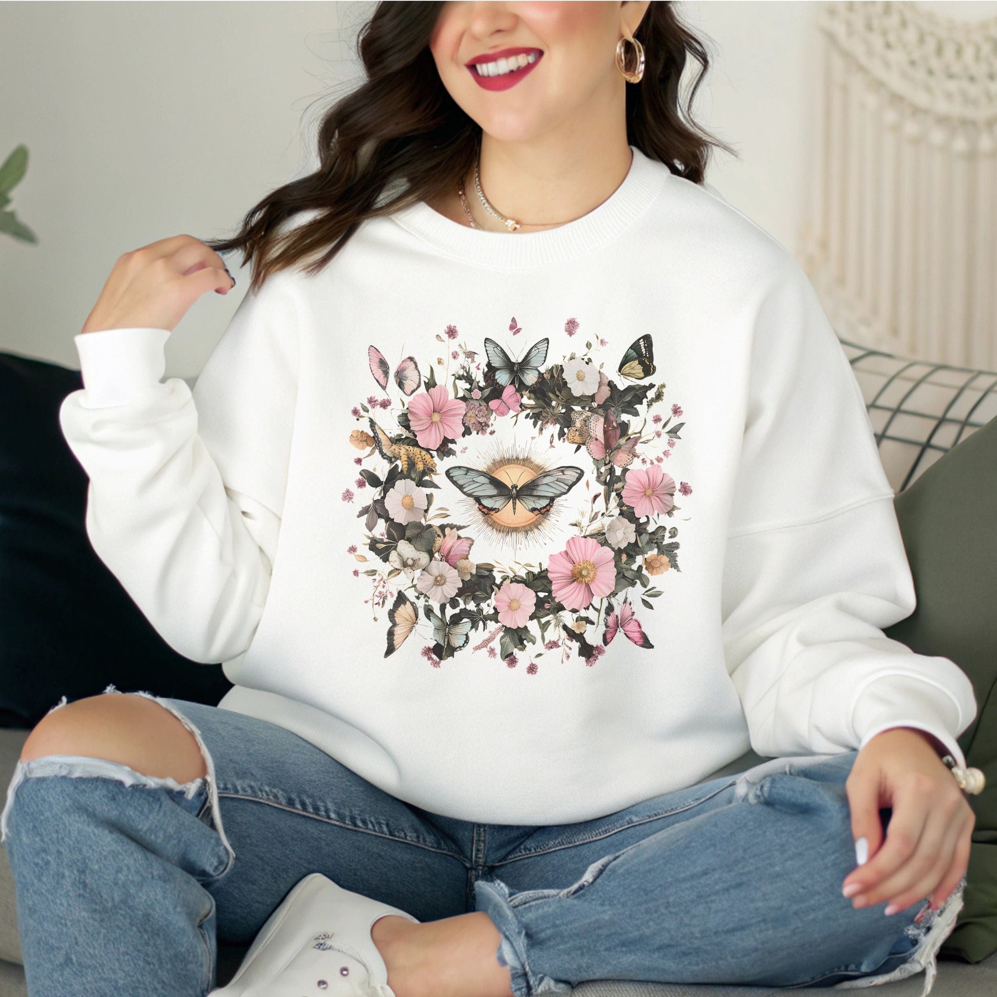 Person wearing a white sweatshirt with floral and butterfly design