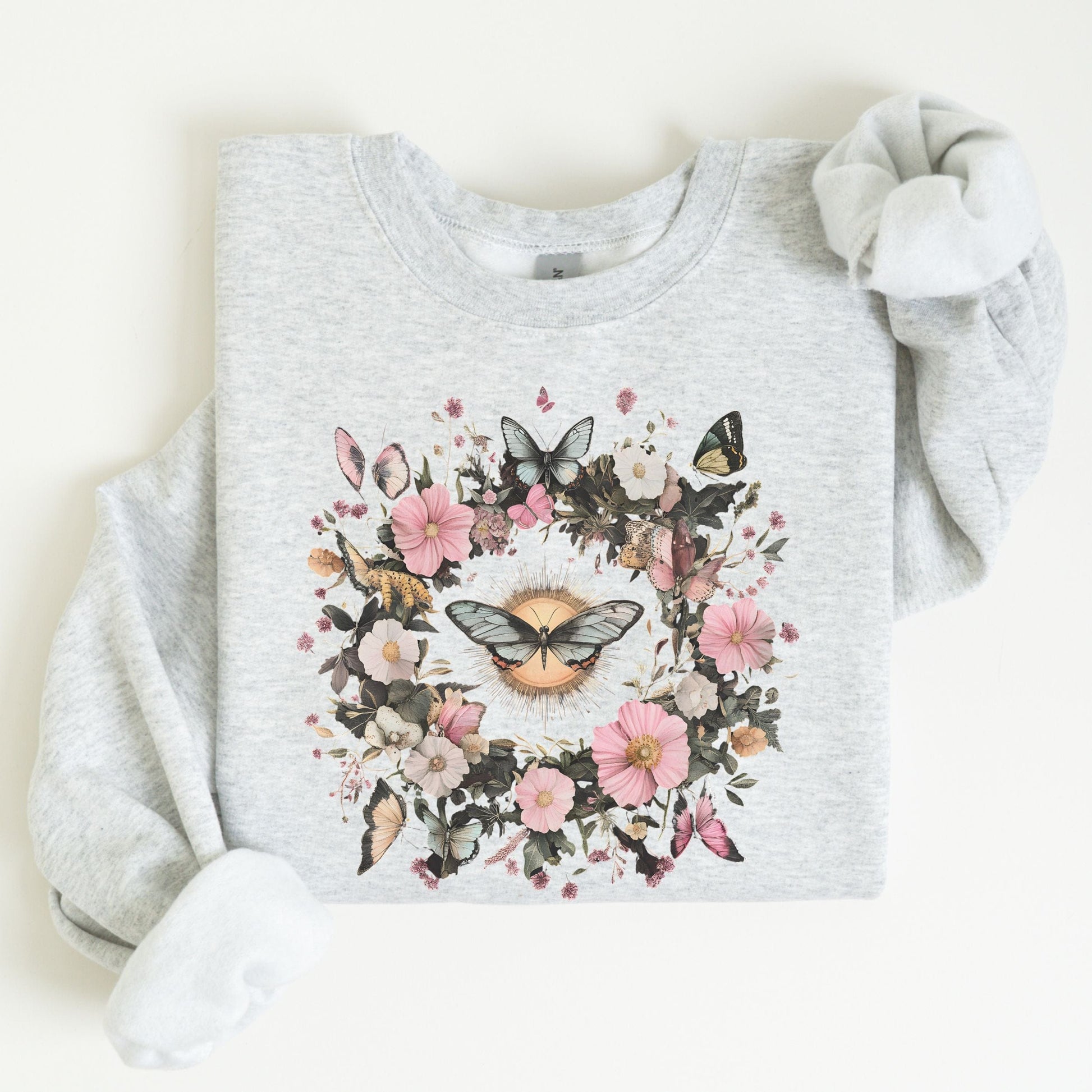 Gray sweatshirt with butterfly and floral design on a white background