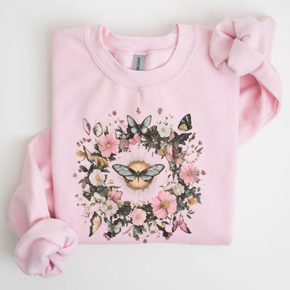 Pink sweatshirt with floral and butterfly design on a light background