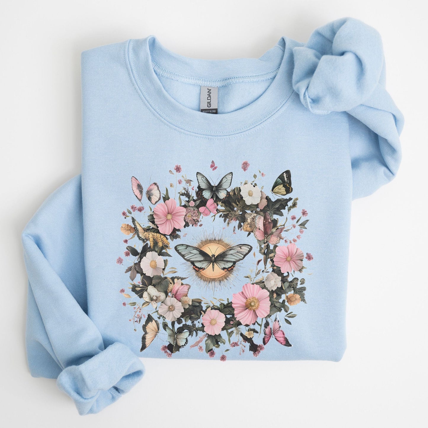 Light blue sweatshirt with floral and butterfly design on a white background