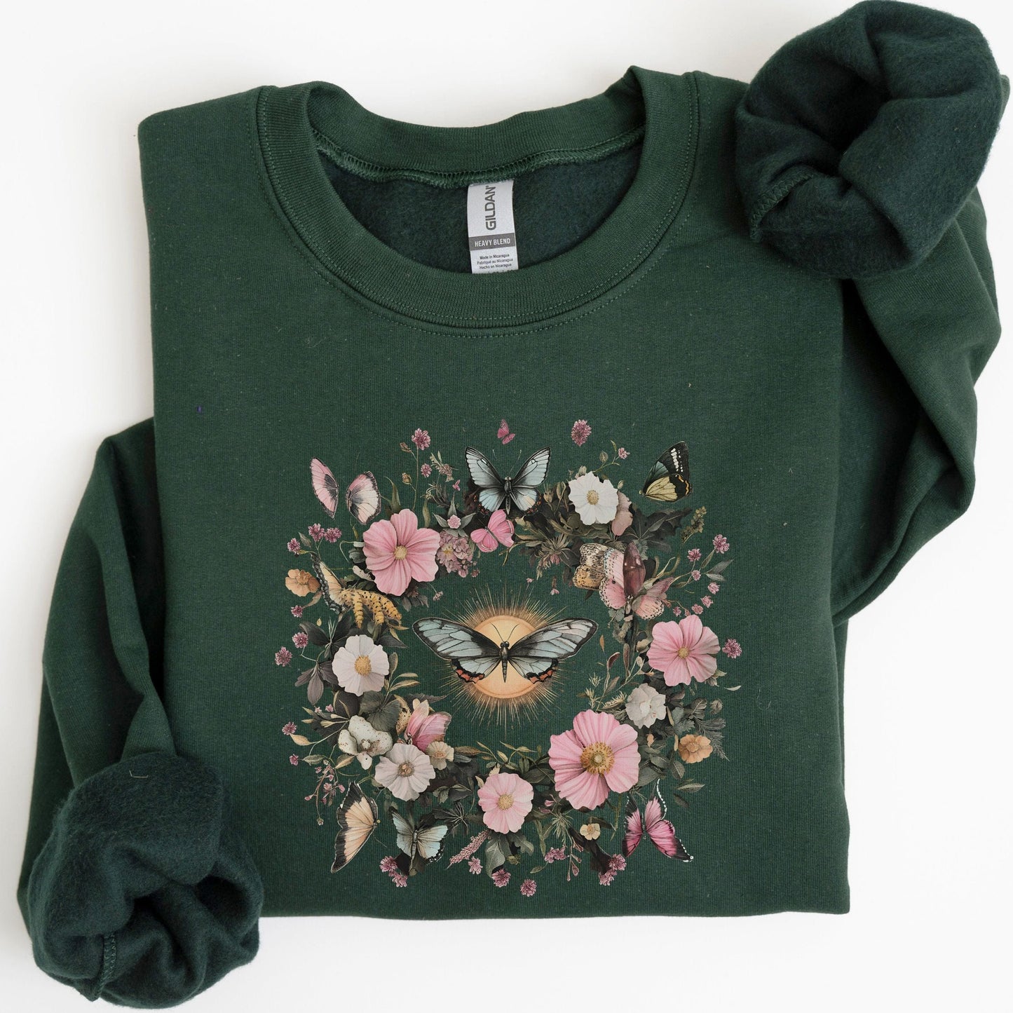 Green sweatshirt with floral and butterfly design on a white background