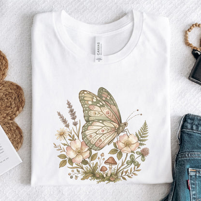 White t-shirt with a butterfly and floral design on a textured surface.