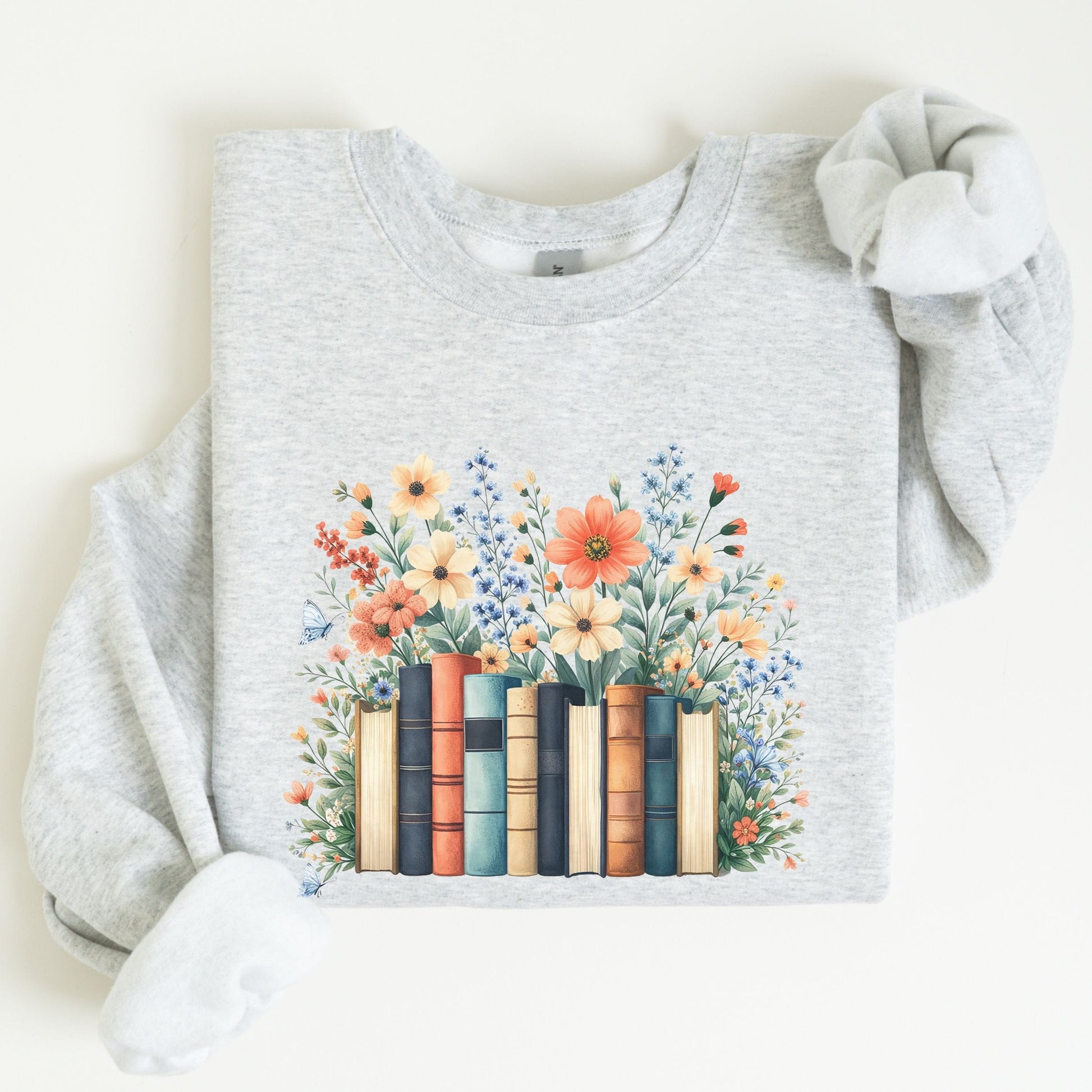 Gray sweatshirt with a design of books and flowers on a white background