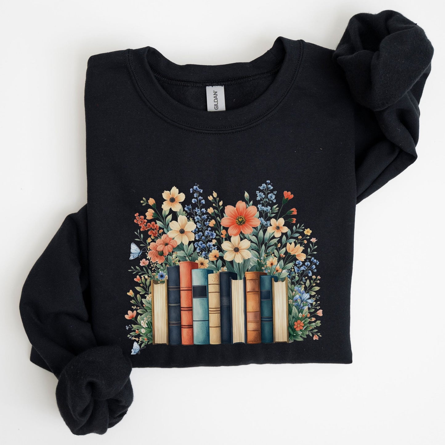 Black sweatshirt with floral and book design on a white background