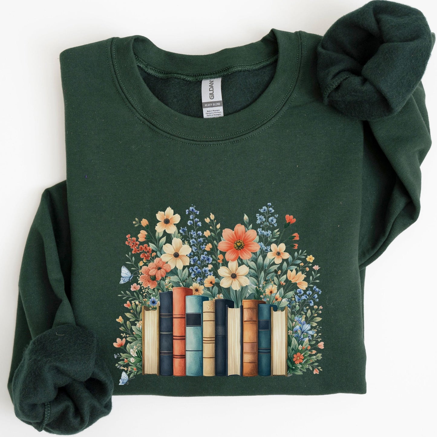 Green sweatshirt with floral and book design on a white background