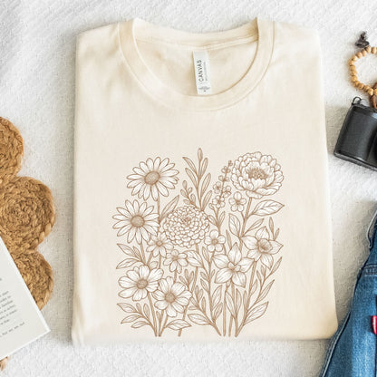 Beige t-shirt with floral design on a textured surface