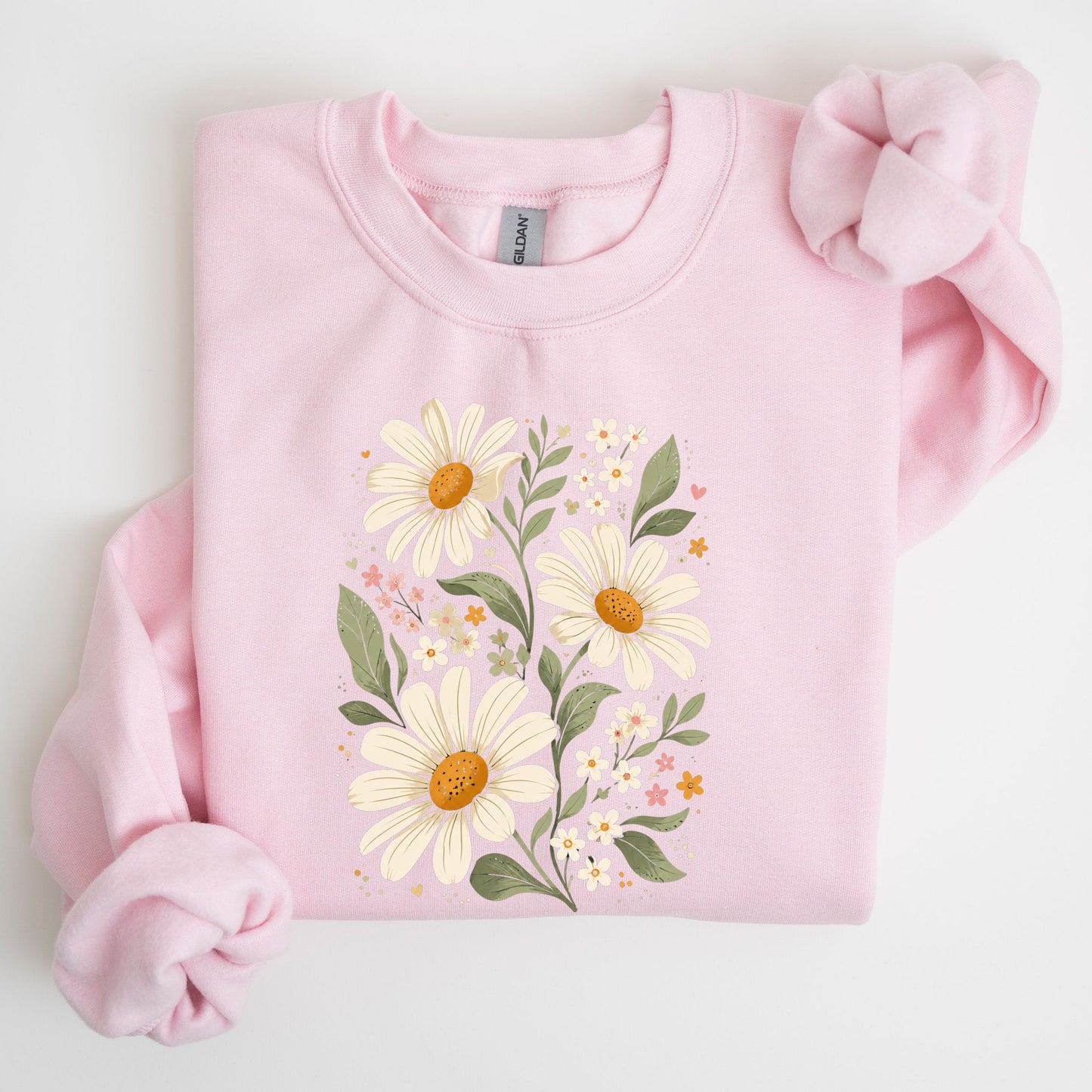 Pink sweatshirt with floral design on a light gray background