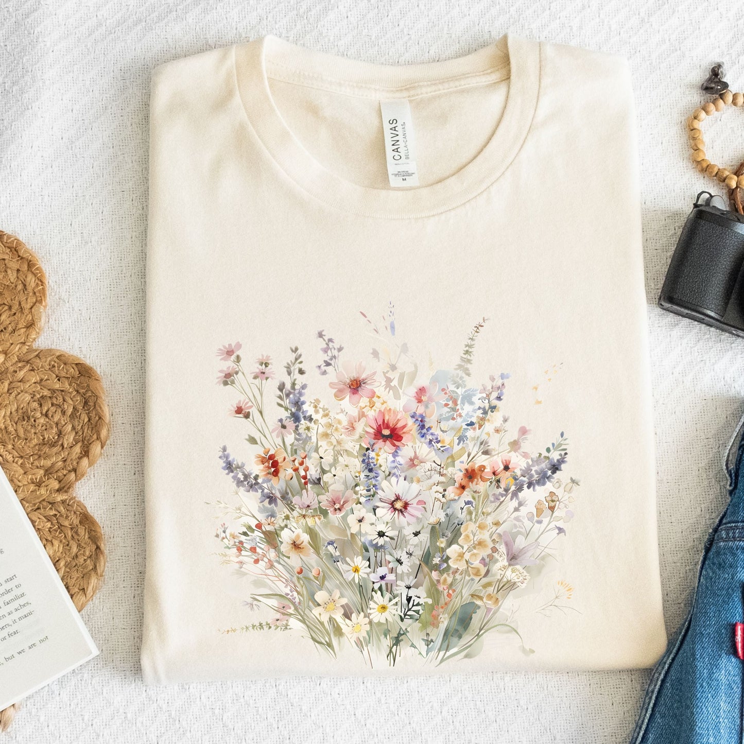 Beige t-shirt with a floral design on a textured surface