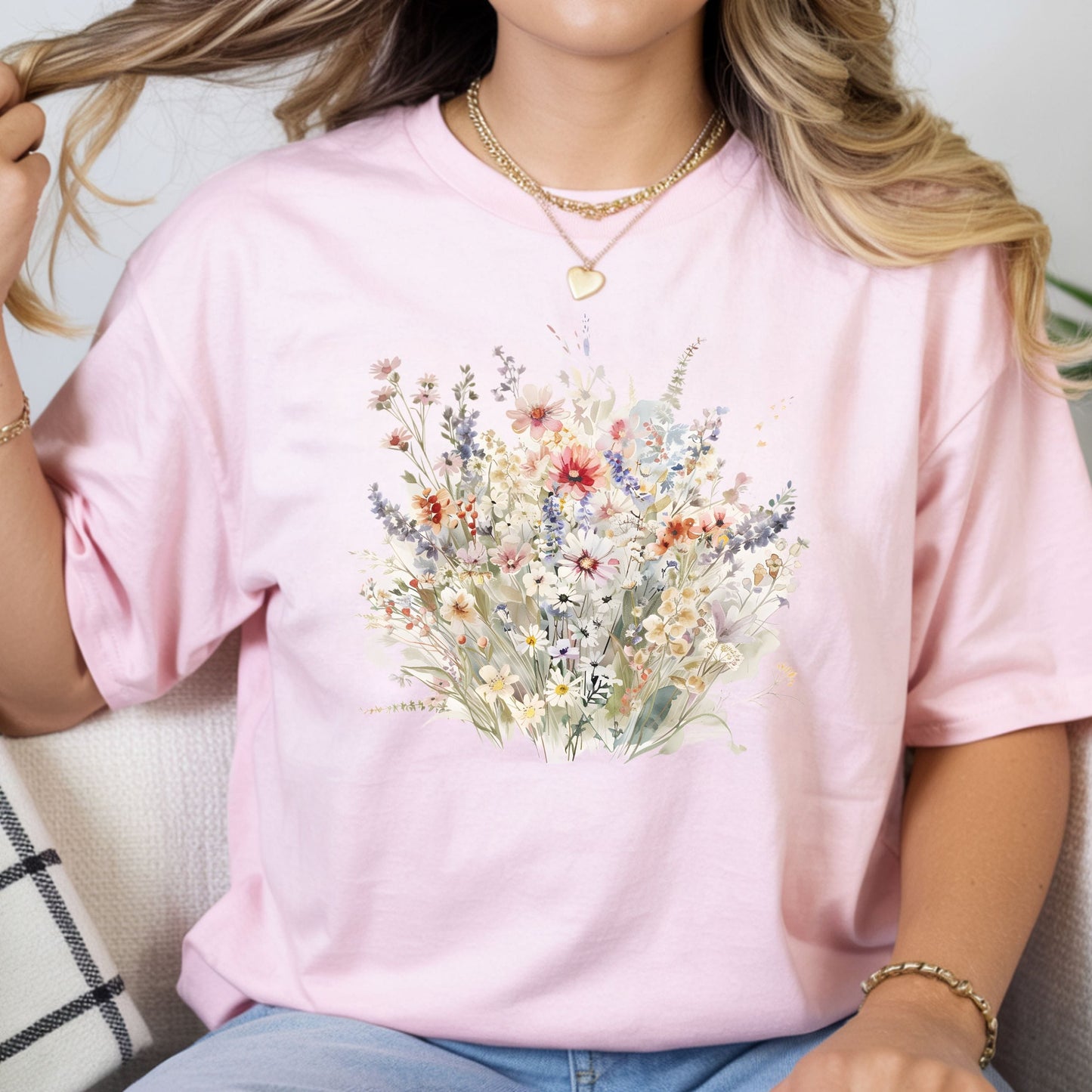 Person wearing a pink t-shirt with a floral design