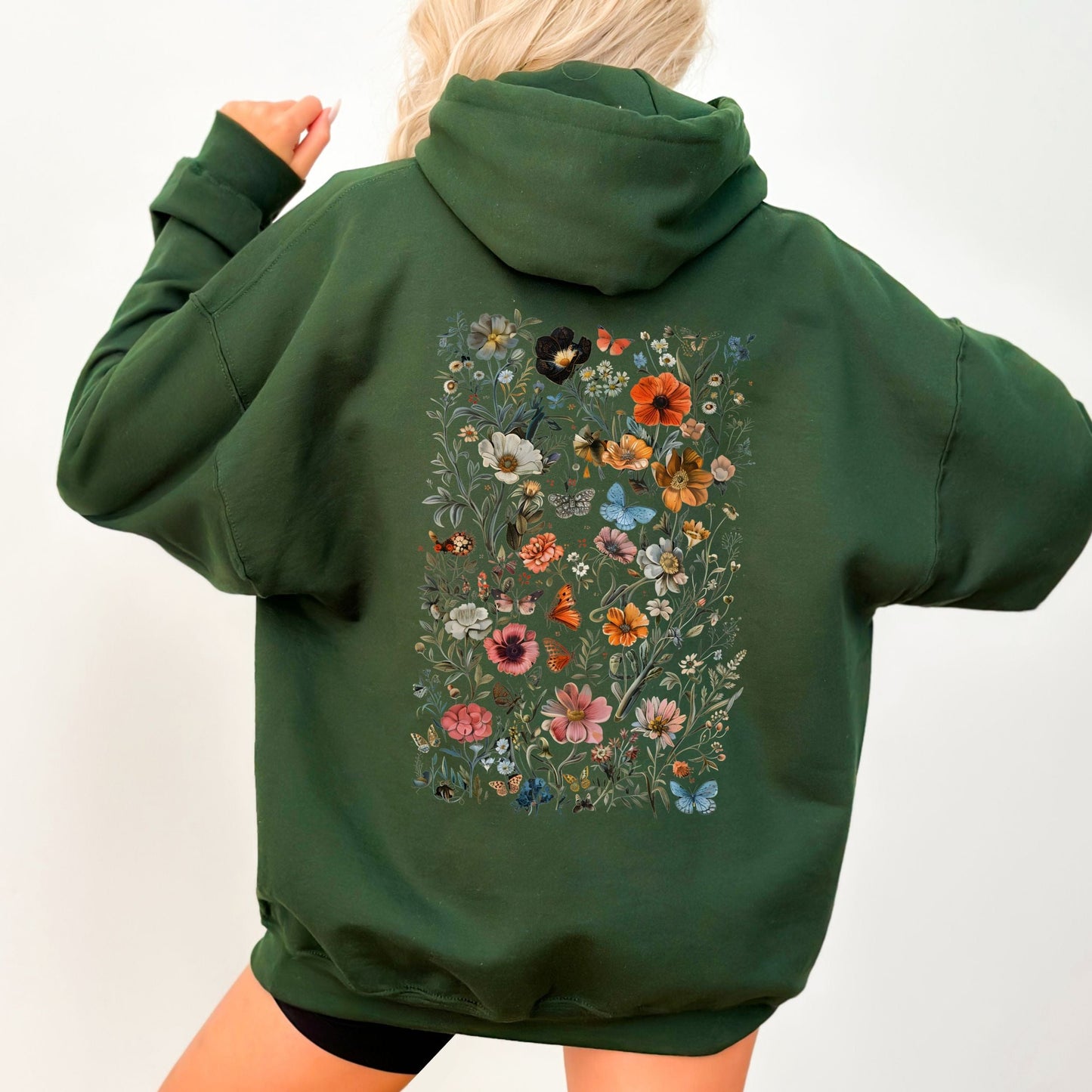 Green hoodie with floral design on the back against a white background