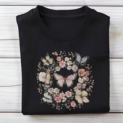 Black t-shirt with butterfly and floral design on a wooden surface