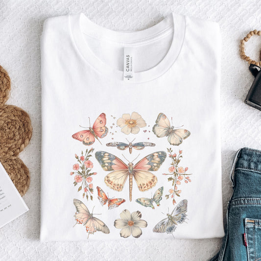 Flat lay of white t-shirt featuring vintage butterfly and floral design