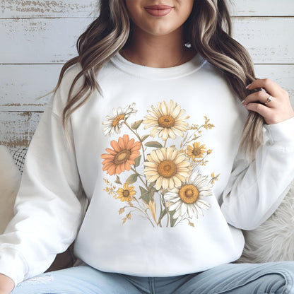 Person wearing a white sweatshirt with floral designs sitting on a wooden floor.