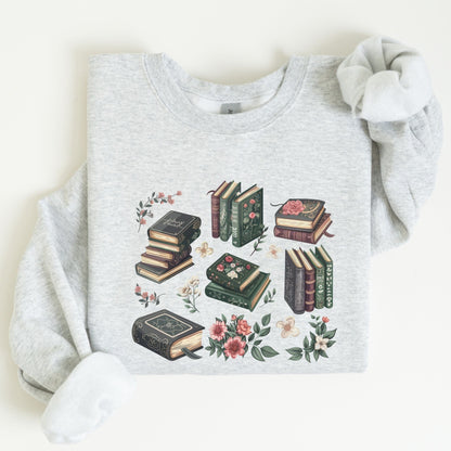 Gray sweatshirt with book and floral design on a light background