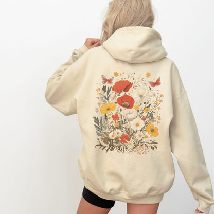 Beige hoodie with floral design on the back worn by a person against a white background