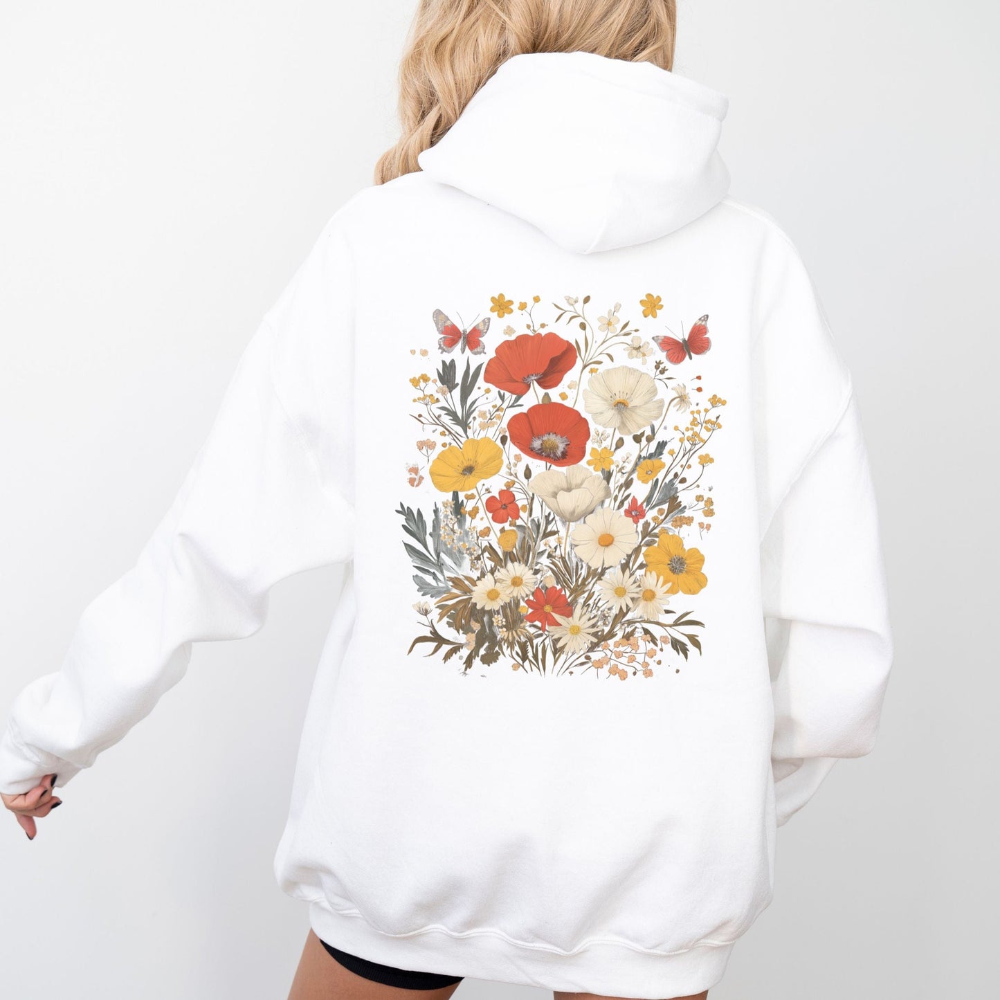 White hoodie with floral design on the back against a white background