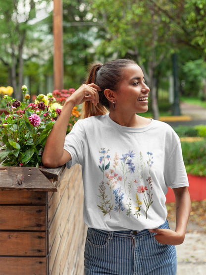 Woman wearing a white t-shirt with floral design in an outdoor setting