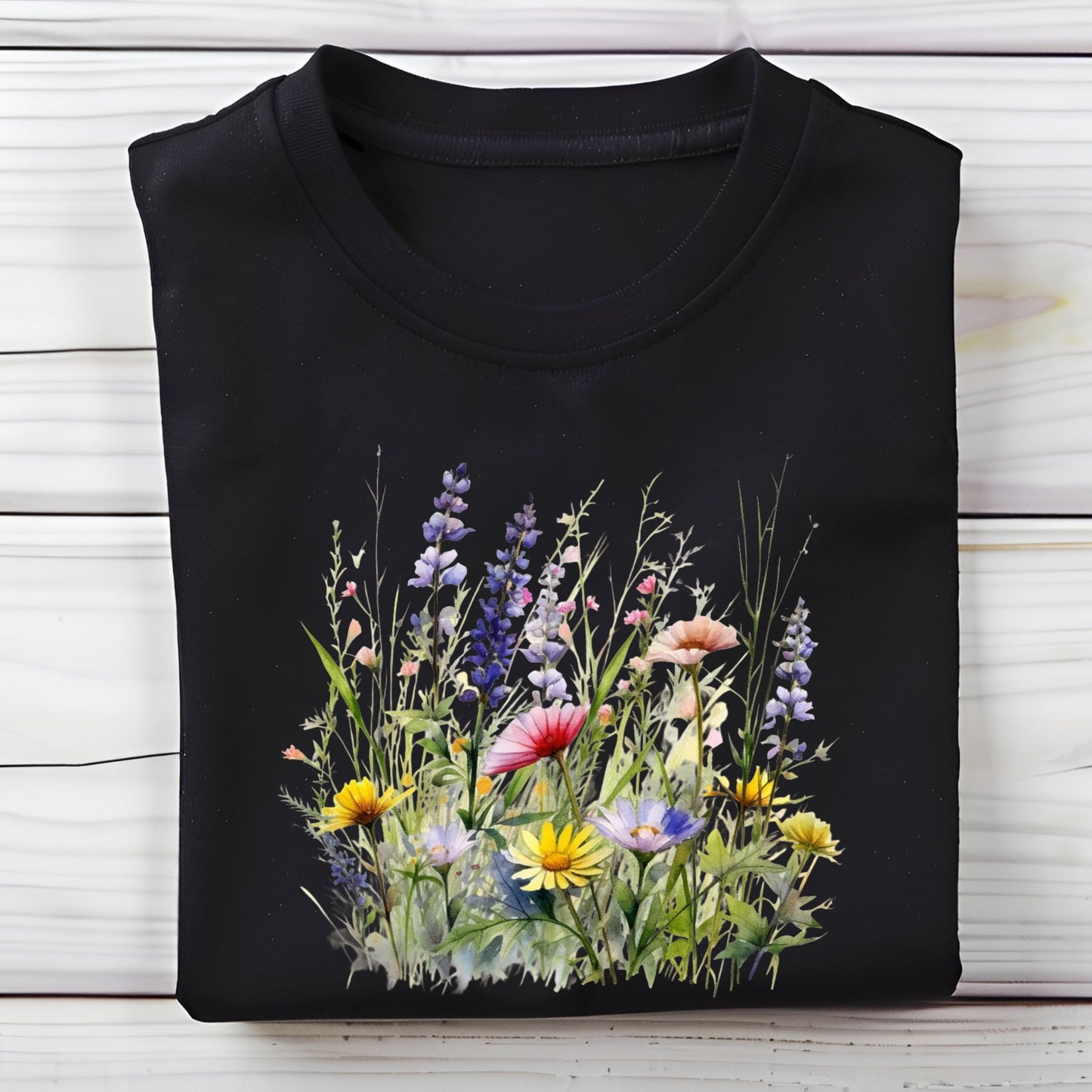 Black long sleeve t-shirt with a colorful floral design on a wooden surface
