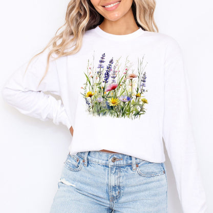 Person wearing a white long sleeve t-shirt with a floral design and blue jeans on a white background