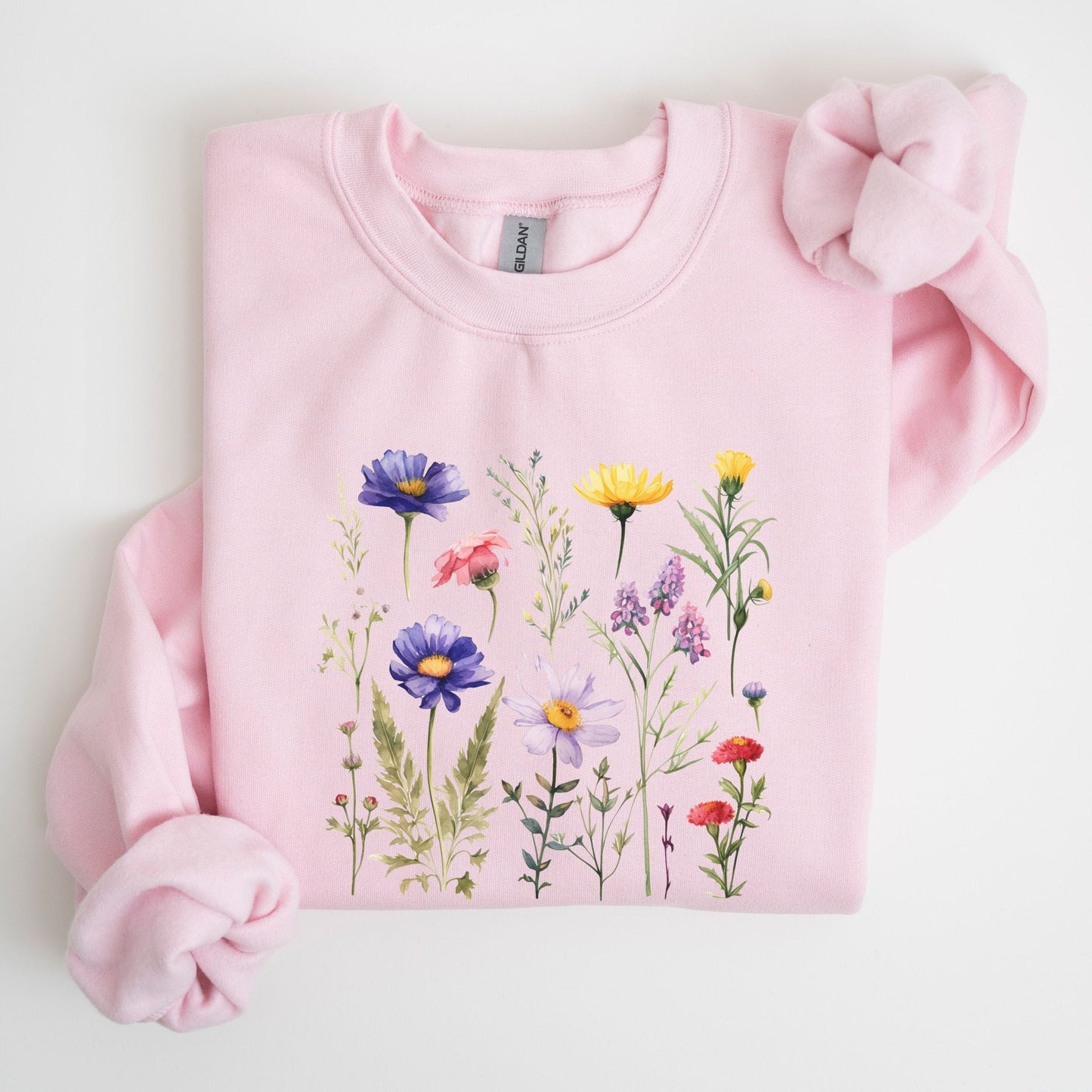 Pink sweatshirt with floral design on a light gray background