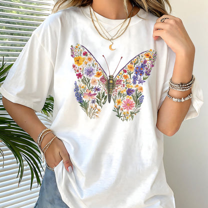 White t-shirt with a colorful butterfly and floral design worn by a person.