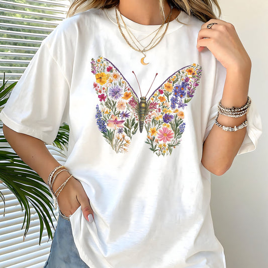 White t-shirt with a colorful butterfly and floral design worn by a person.