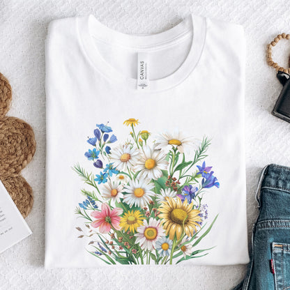 White long sleeve t-shirt with colorful floral design on a textured surface.