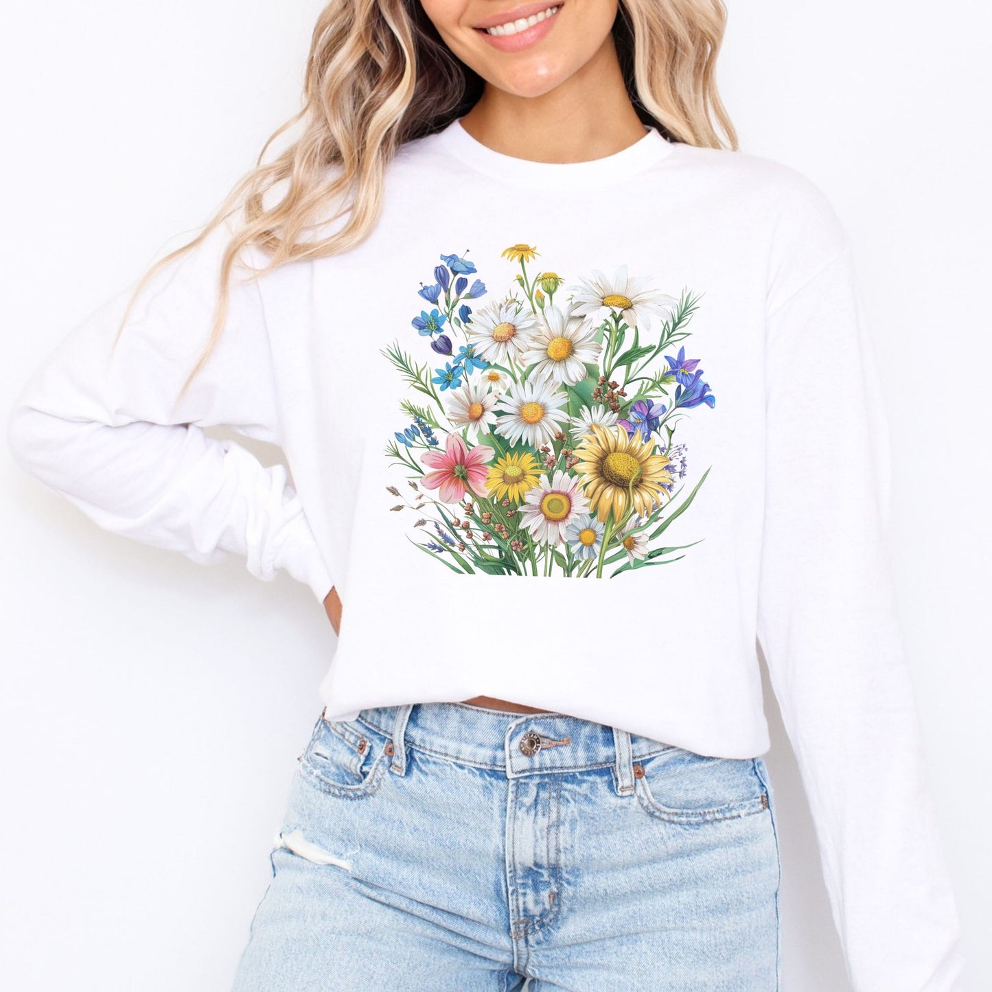 Person wearing a white long sleeve t-shirt with a floral design on a plain background