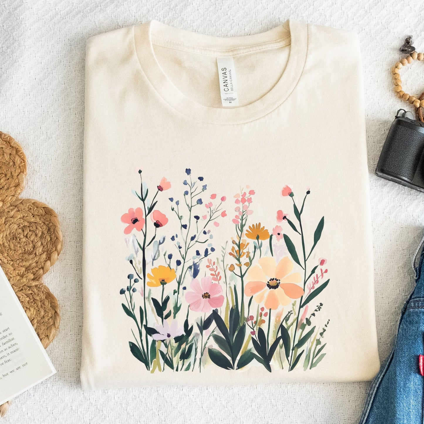 Beige t-shirt with floral design on a white surface