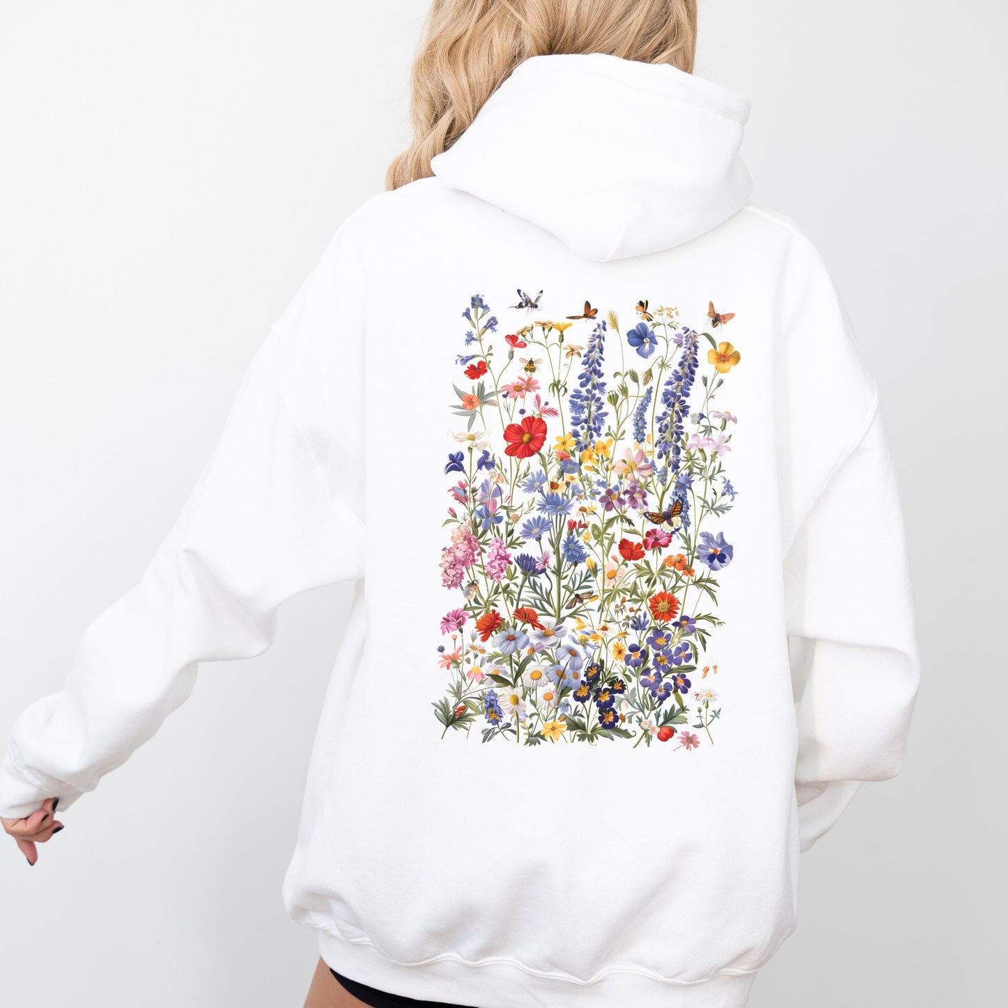 White hoodie with a colorful floral design on the back against a white background