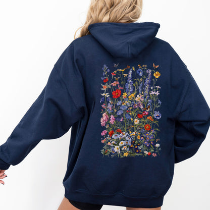 Navy blue hoodie with floral design on the back worn by a person