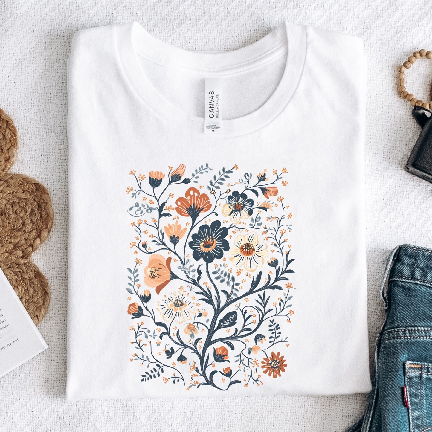 White t-shirt with a floral design on a textured surface