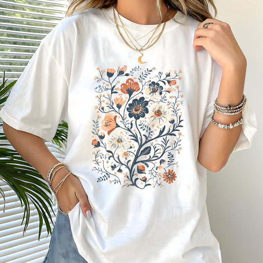 White t-shirt with floral design worn by a person, with a neutral background